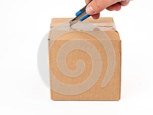 Cardboard box on a white background. Open the cardboard boxes with a utility knife.