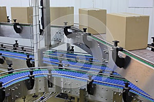 Cardboard boxes on conveyor belt in factory photo