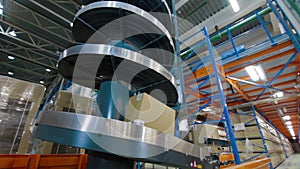 Cardboard boxes on conveyor belt inside warehouse