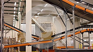 Cardboard boxes on conveyor belt inside warehouse