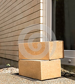 cardboard boxes delivered to the forn door and left outside for contactless pickup, delivery for online shopping