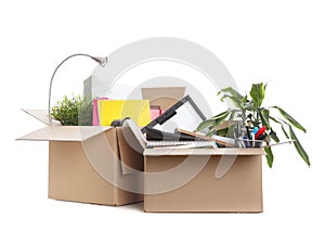 Cardboard boxes full of office stuff on white