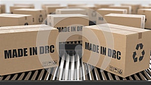 Cardboard boxes with Made in DRC text on roller conveyor