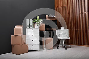 Cardboard boxes and packed belongings in office