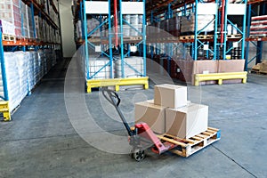 Cardboard boxes on a pallet jack in warehouse