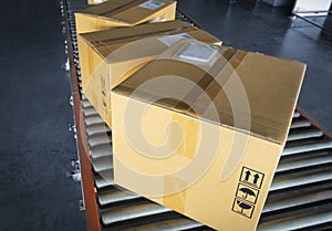 Cardboard boxes sorting on roller conveyor at the warehouse. Shipment boxes. Store warehousing. Storage warehouse.