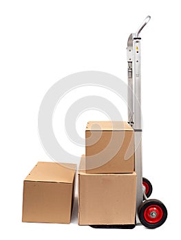 Cardboard boxes with a trolley on a white background, cardboard boxes on a wheelbarrow.