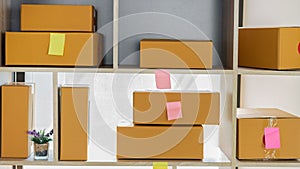 Cardboard boxes at work, small business entrepreneurs, SMEs, also work with boxes at home, selling e-commerce ideas online.