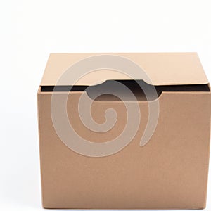 Cardboard brown box or kraft package box on a white background. Postal parcel or package. Free space for text. Copy