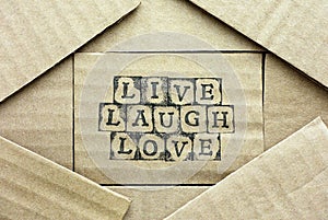 Cardboard card with words Live Laugh Love