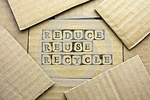 Cardboard card with words Reduce Reuse Recycle