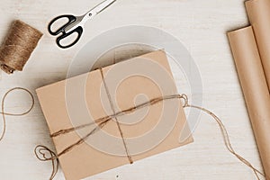 Cardboard carton wrapped with brown paper and tied with string