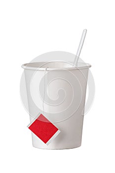 Cardboard disposable cup with tea bag and spoon on white