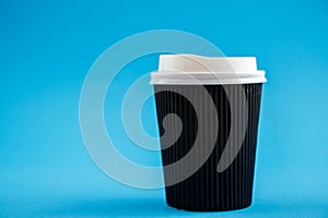 Cardboard disposable cups isolated on a blue background. Front view