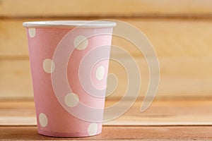 Cardboard disposable cups isolated on a wooden background. Front view