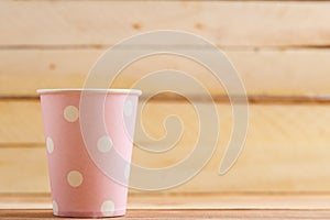 Cardboard disposable cups isolated on a wooden background. Front view