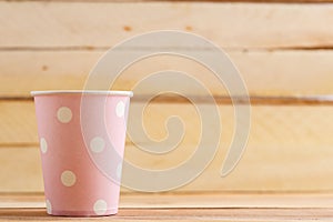 Cardboard disposable cups isolated on a wooden background. Front view