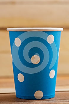 Cardboard disposable cups isolated on a wooden background. Front view