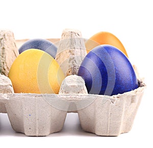 Cardboard egg box with Easter colored eggs