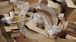 Cardboard and film waste. Used shipping boxes. Sheets or stiff multi layered papers that have been used, discarded or