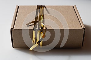 Cardboard gift box with golden ribbon, handmade present - Image