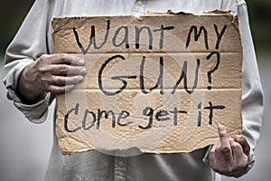 Cardboard handwritten sign, Want My Gun? Come Get It, gun laws, gun control