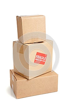 A cardboard moving box with a fragile sticker