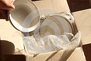 Cardboard Packing Box, Plates and Bubble Wrap photo