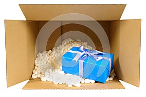Cardboard shipping delivery box with blue gift inside and polyst