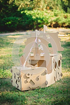 Cardboard toy boat in the park.