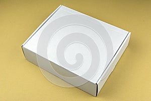 Cardboard white box on beige background. Packing box in stock