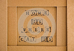 Cardboard with words Home Is Where Cat Is