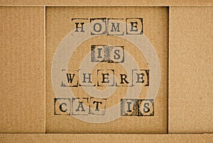 Cardboard with words Home Is Where Cat Is