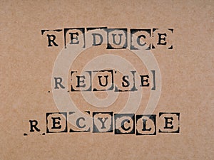 A cardboard with words Reduce, Reuse, Recycle