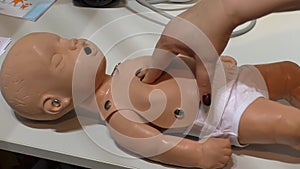 Cardiac massage on baby mannequin