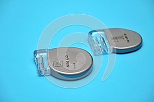 Implantable pacemaker devices on a blue background. photo