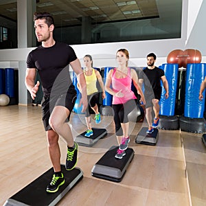 Cardio step dance group at fitness gym training