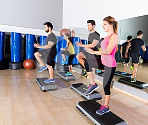 Cardio step dance group at fitness gym training