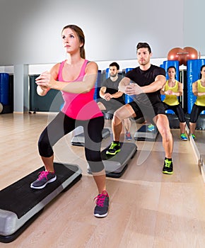 Cardio step dance squat group at fitness gym