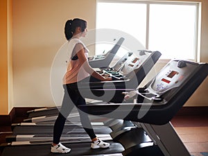 Cardio workout. Fit women running on treadmills doing cardio training in a gym,Healthy lifestyle concept