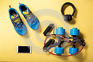Cardio workout. Running sneakers and jump rope. Jump rope and dumbbells. Cardio with music. Flat lay.