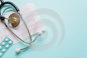 Cardiogram and stethoscope on blue