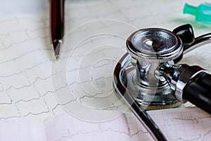 Cardiogram with stethoscope on table, closeup