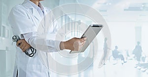 Cardiologist doctor with stethoscope analyzing patient data on tablet in hospital background, Healthcare and medical technology