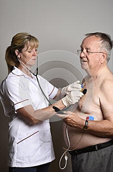 Cardiologist installs a ECG heart monitor onto a patient