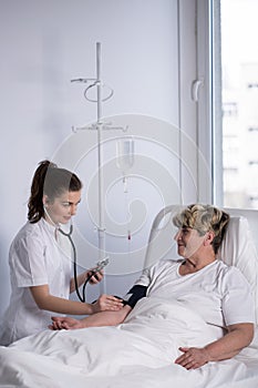 Cardiologist measuring blood pressure photo