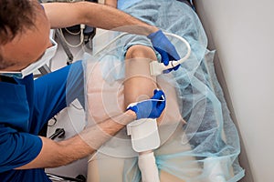 Cardiologist use tubes and ultrasound for radiofrequency catheter ablation.