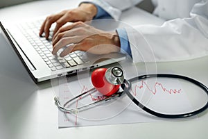 Cardiology - doctor cardiologist working on laptop in office photo