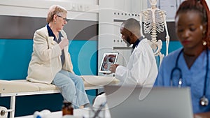 Cardiology medic showing cardiogram diagnosis on digital tablet