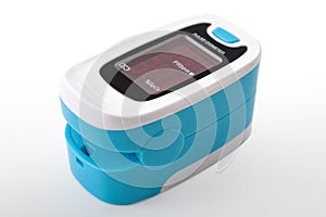 Cardiovascular health, oxygen saturation level and blood testing electronic device concept with pulse oximeter isolated on blue